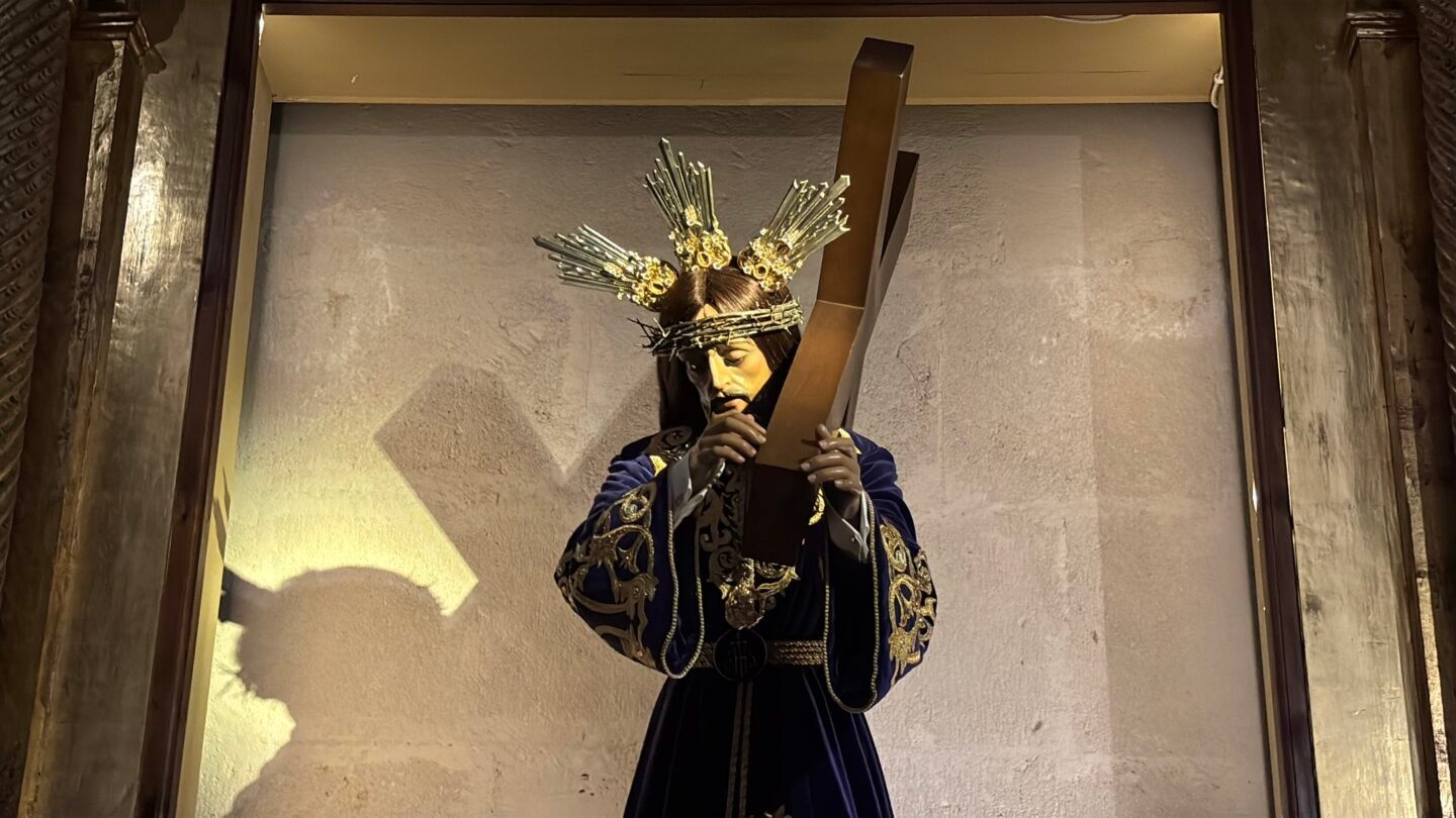 Escultura procesional de Jes&uacute;s Nazareno cargando la cruz de madera, conservada en una capillita o vitrina dentro de la Concatedral de San Nicol&aacute;s de Bari en Alicante. Viste una t&uacute;nica de terciopelo morado con bordados dorados y lleva la corona de espinas con potencias doradas.